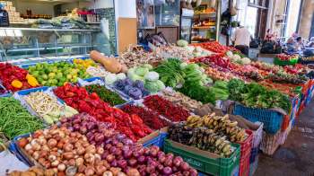 A colorful display of various fruits and vegetables in an outdoor market stall in Cyprus.