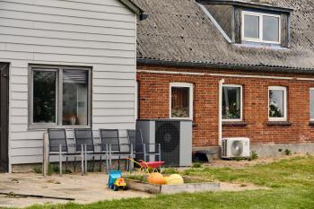 Heat pumps near a farmhouse.