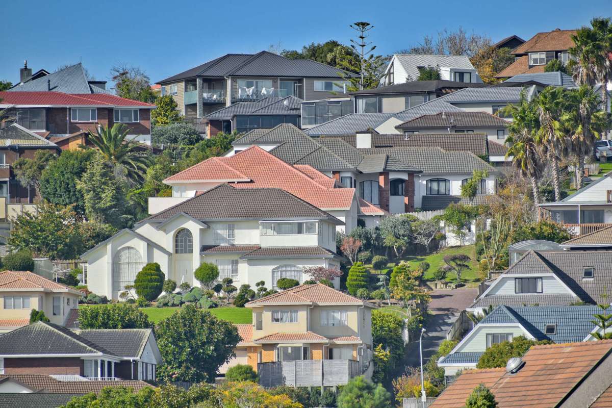 A hillside view of residential houses with varied designs and landscaping.