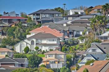A hillside view of residential houses with varied designs and landscaping.