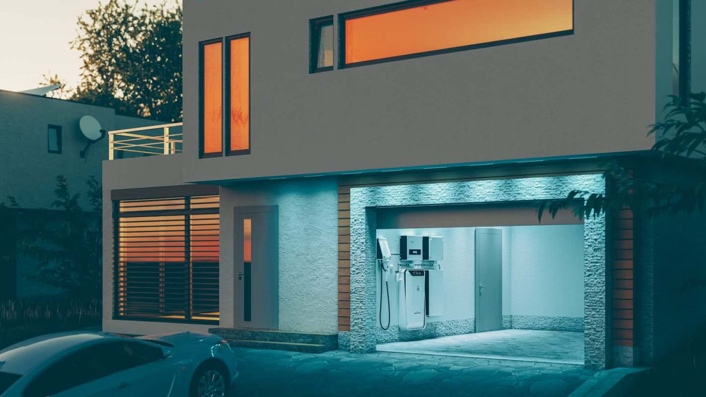 A modern house with large windows and an electric vehicle charging station in the garage.