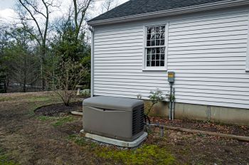 A generator outside of a house.