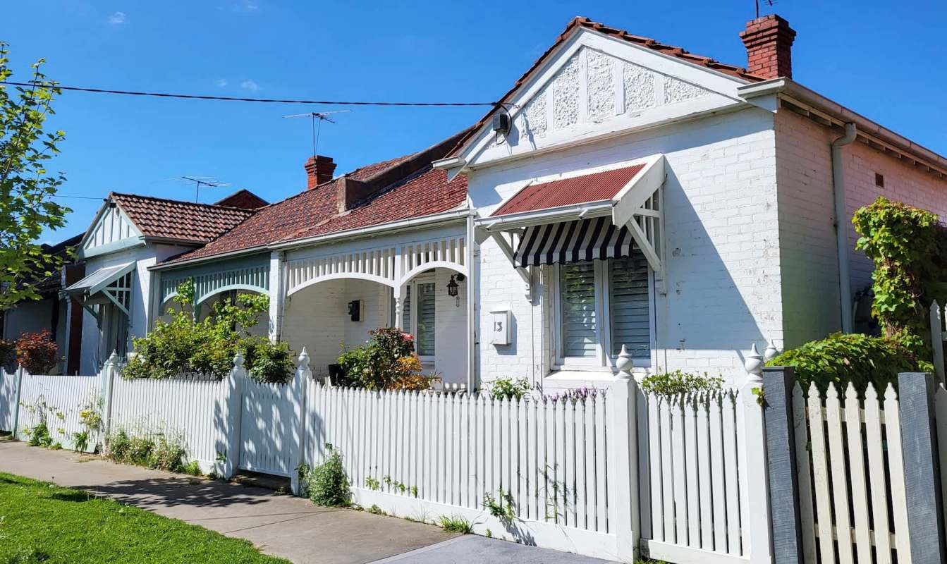 A house with a white picket fence.