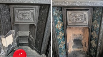 A fireplace with detailed metalwork, one side cleaned and revealing colored tiles, the other side still dirty.