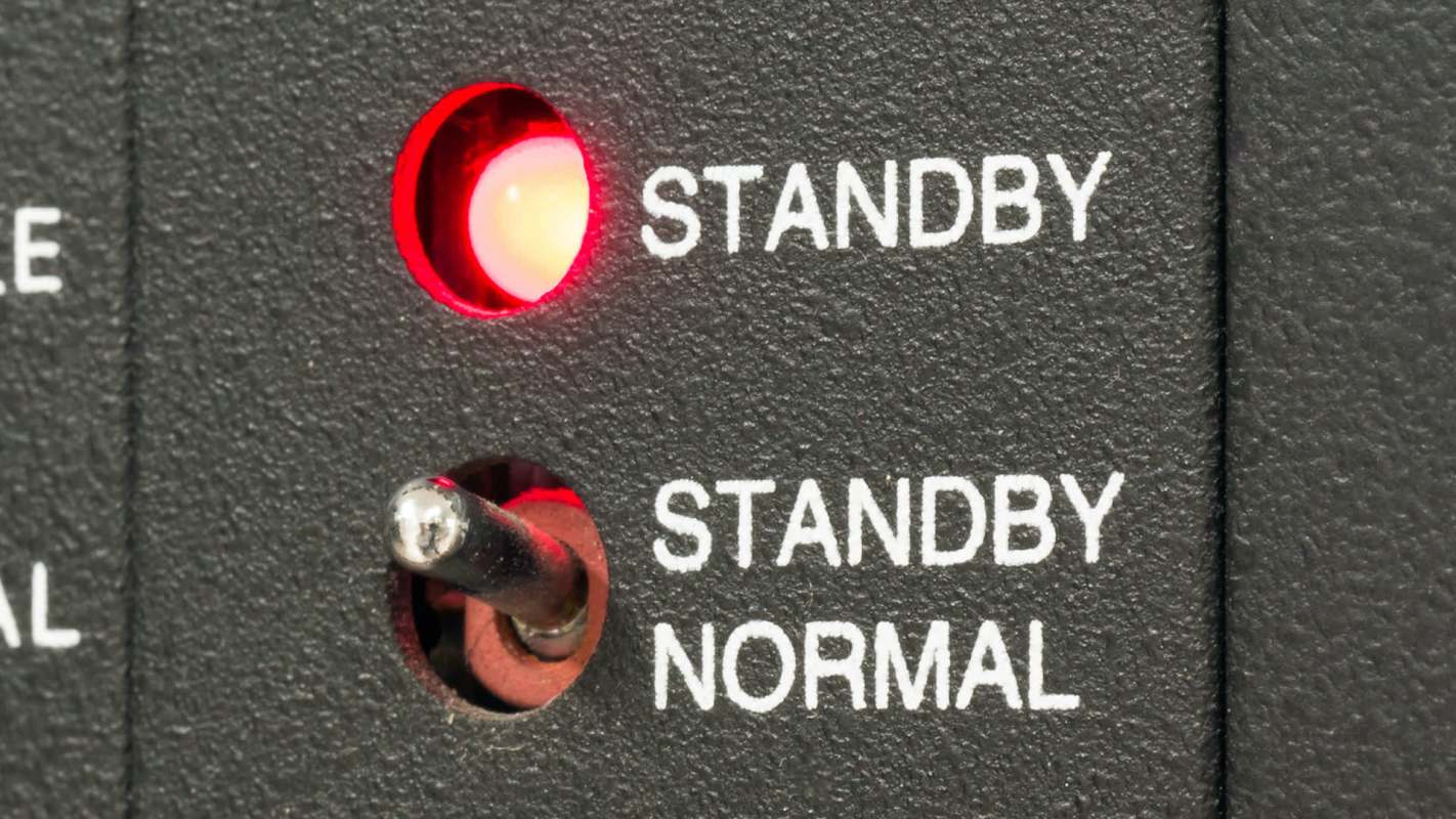 A control panel with a red standby light and a toggle switch labeled "STANDBY" and "NORMAL."