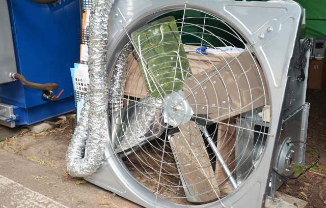 An industrial fan with a metal frame.