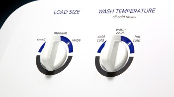 A washing machine control panel with dials for load size and wash temperature settings.