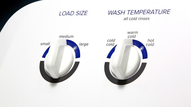 A washing machine control panel with dials for load size and wash temperature settings.