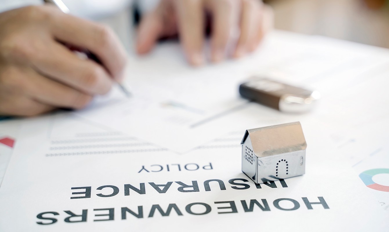 A person signing insurance paperwork.