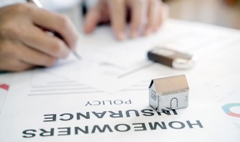 A person signing insurance paperwork.