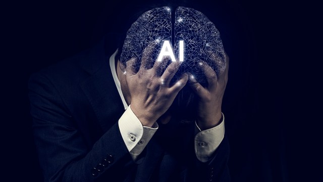 A person in a suit holds their head with a digital brain graphic displaying "AI."