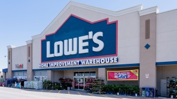 A Lowe's home improvement warehouse with garden supplies displayed outside.