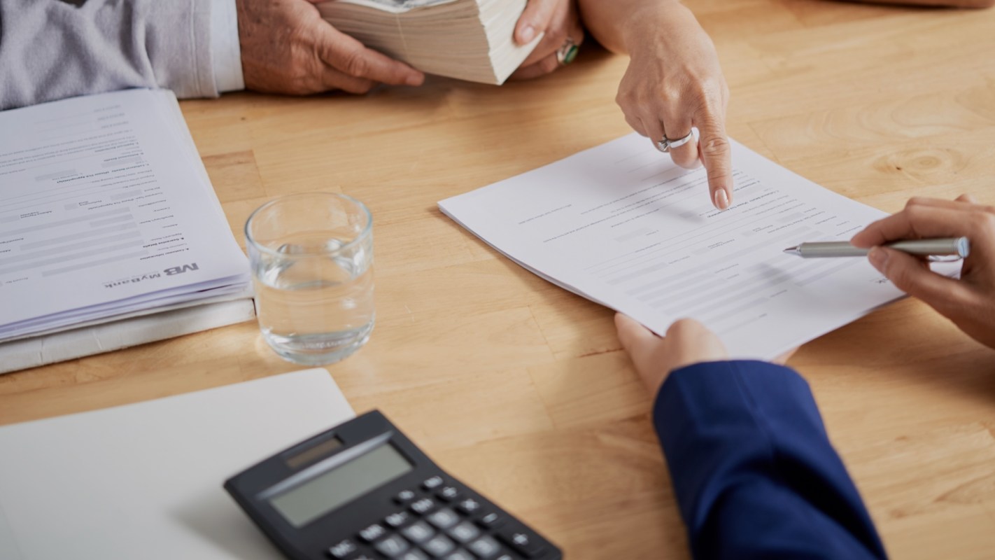 People reviewing paperwork at a desk.