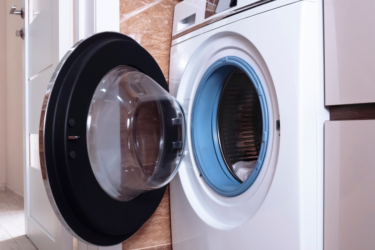 A washing machine with a transparent door and a blue interior.