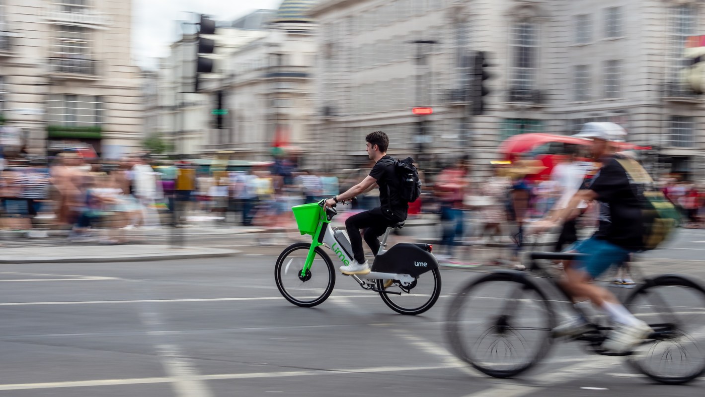 A person on an e-bike cycling through an intersection.
