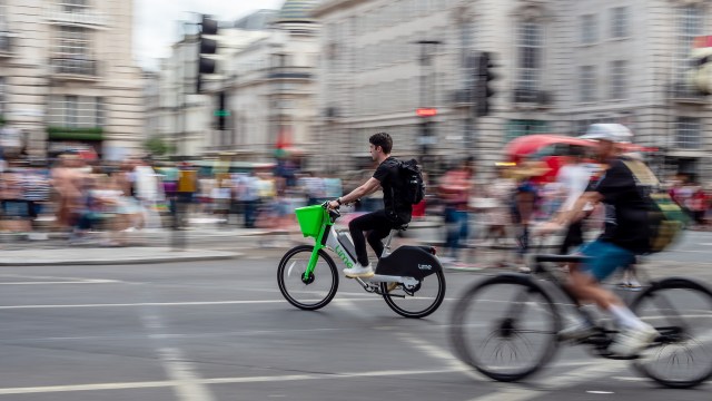 A person on an e-bike cycling through an intersection.