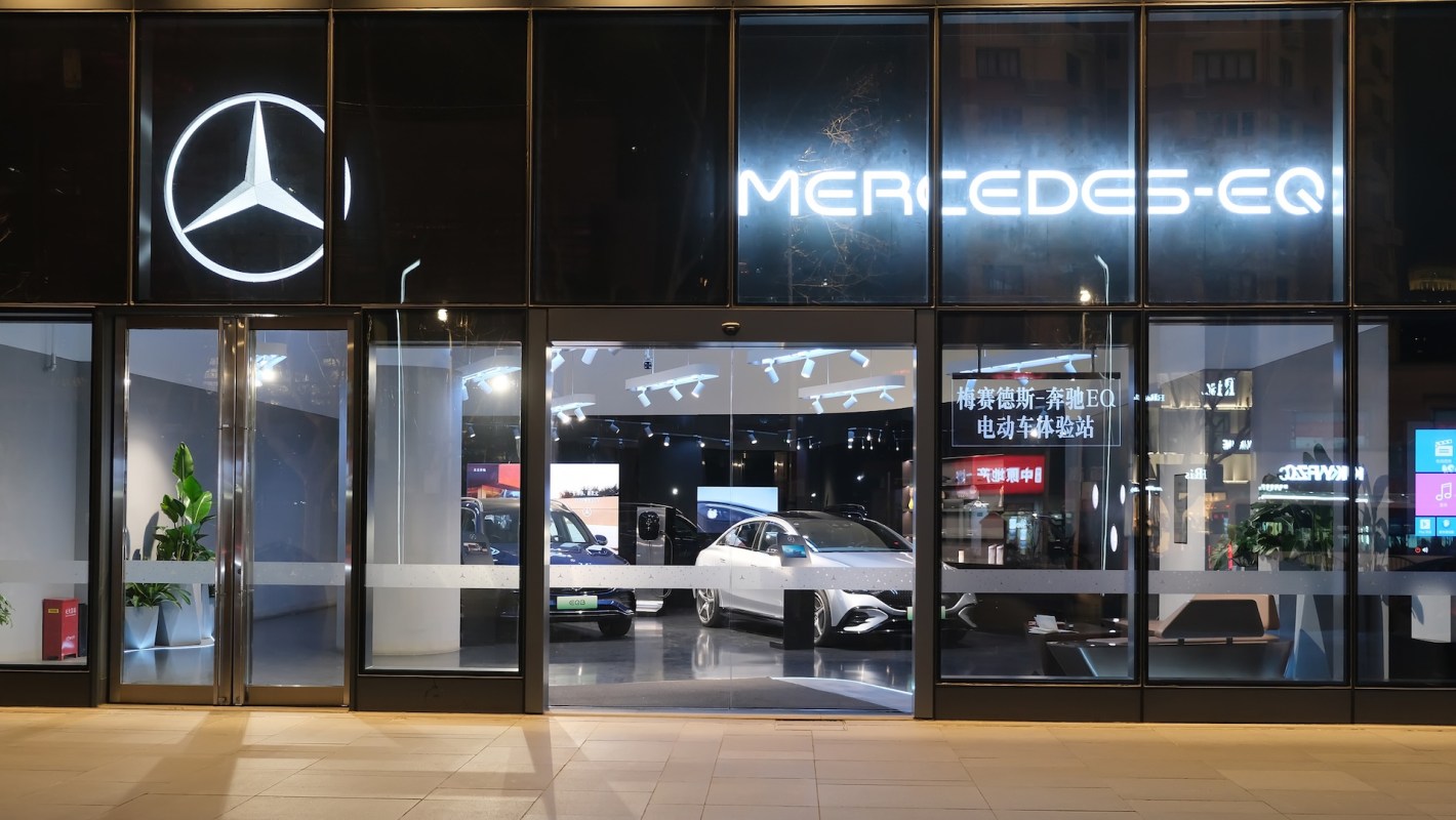 A Mercedes-Benz EQ dealership showcasing electric cars behind large glass windows with Chinese characters.