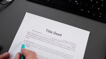 A person reviewing a title deed.