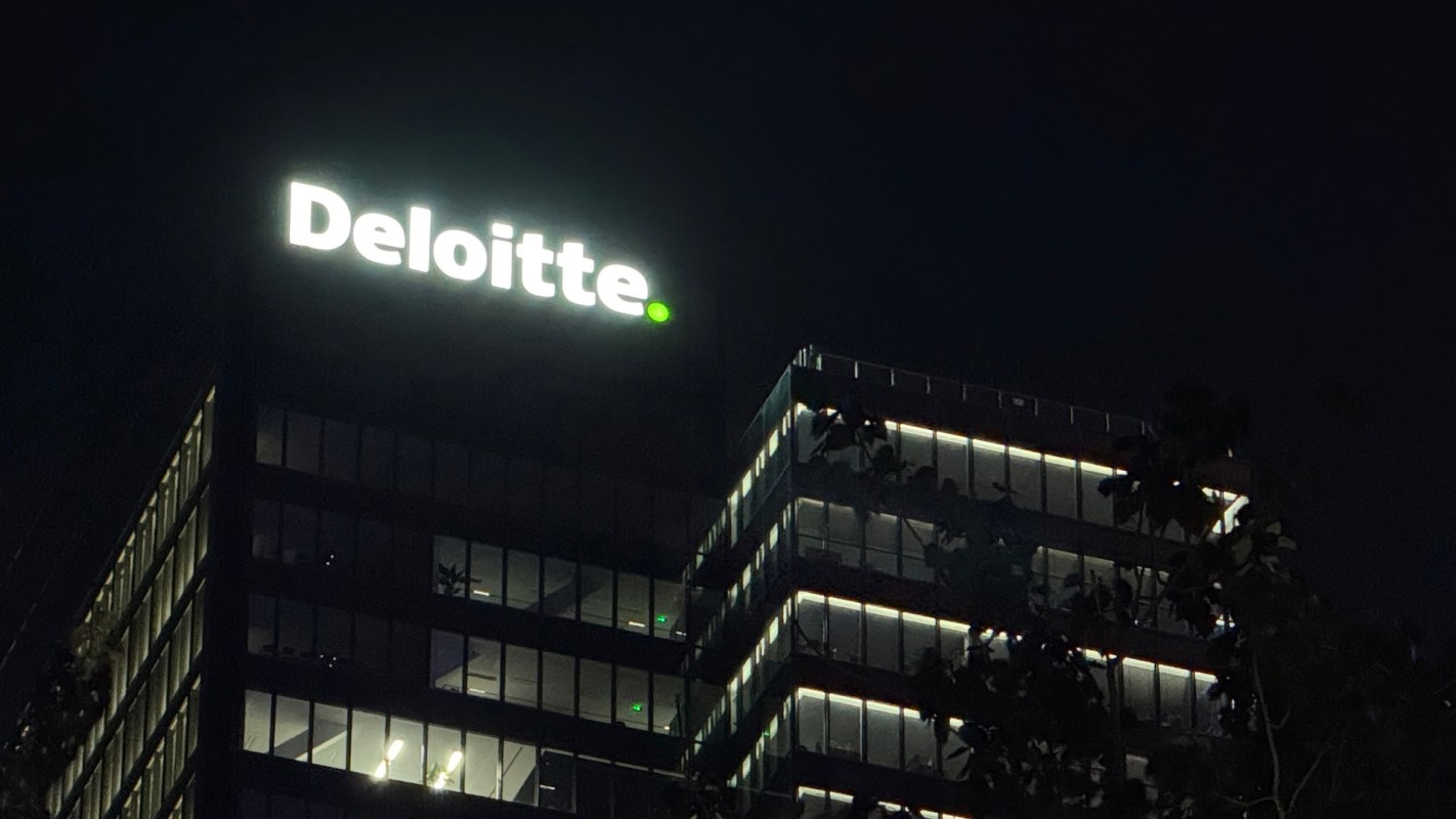 A Deloitte building at night.