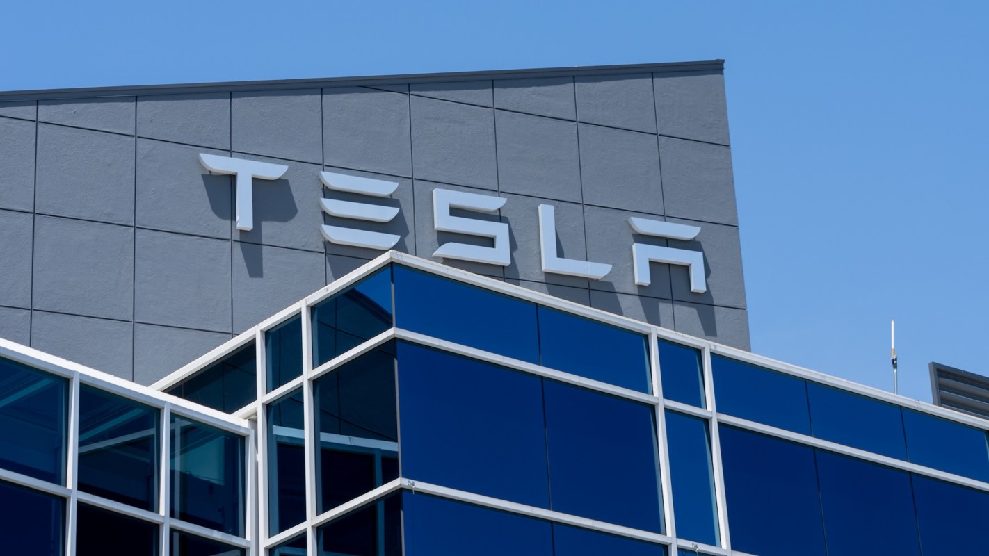 The Tesla logo displayed on the exterior of a modern building.