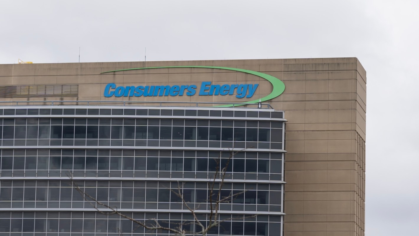Signage for Consumers Energy on a multistory building with large windows.