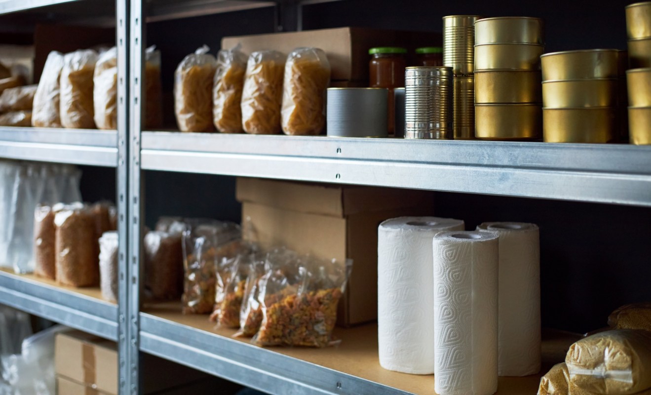 Shelves with emergency supplies and shelf-stable food.