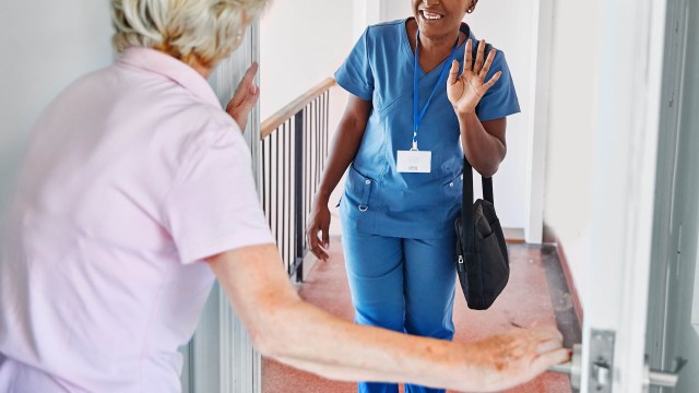 A nurse greeting an elderly person.