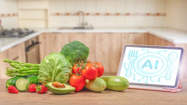 A variety of digitally generated vegetables arranged on a wooden countertop next to a digital tablet displaying "AI."