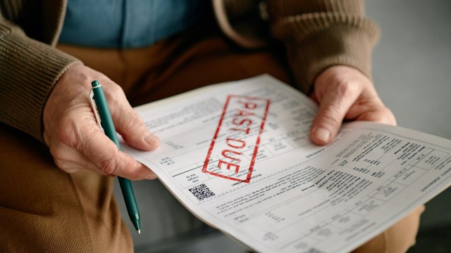 A senior person holds a document marked "PAST DUE" with a pen in hand.