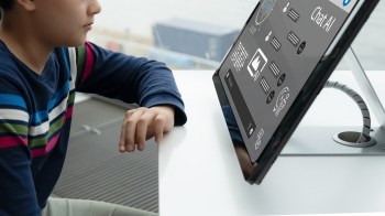 A child interacts with a touchscreen display showing a Chat AI interface.
