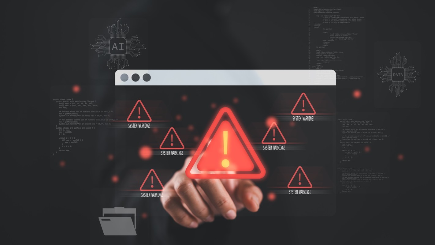A hand points at a computer screen with system warning alerts.