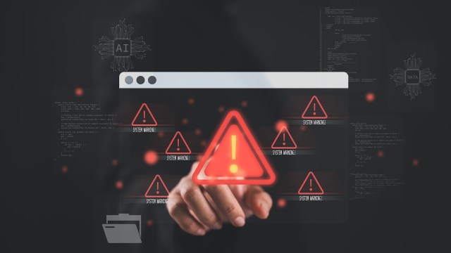 A hand points at a computer screen with system warning alerts.