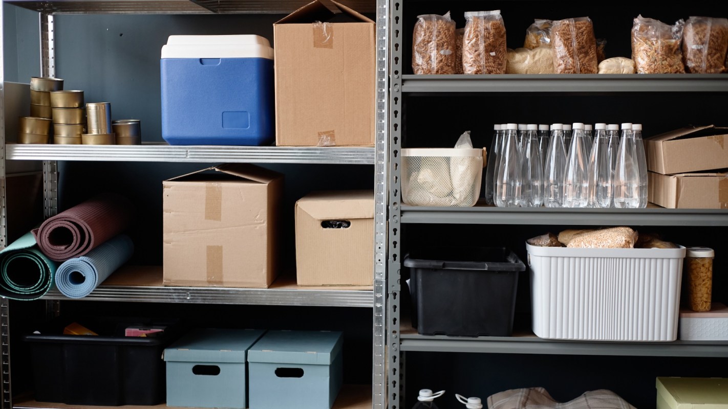 A storage area with shelves containing boxes, containers, and various food items.