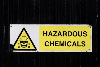 A sign warning of hazardous chemicals with a skull and crossbones symbol.