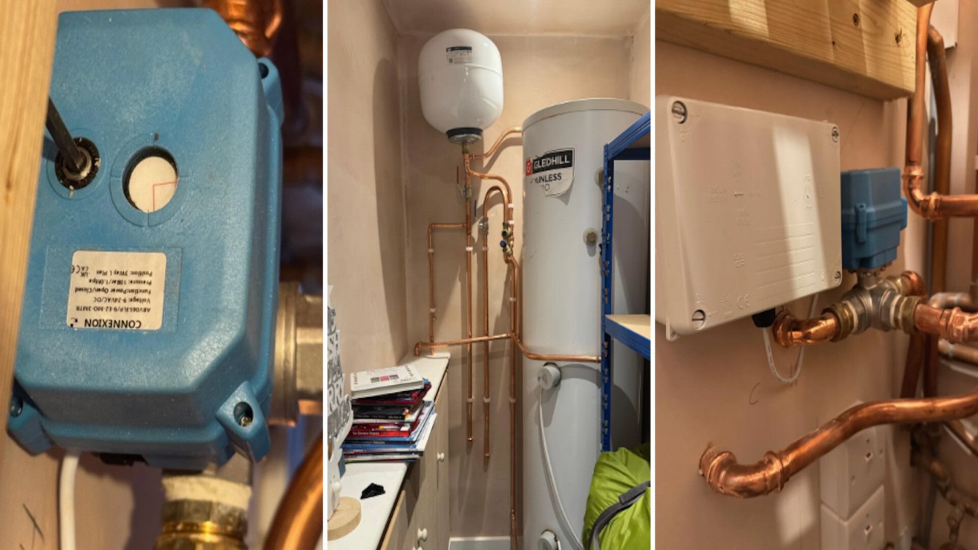 Various plumbing installation components, including a water heater, pipes, and a control box, in a utility room.