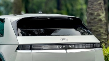 A Hyundai Ioniq 5 parked among greenery.