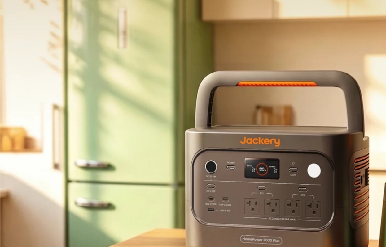 A Jackery portable power station on a countertop with a green refrigerator in the background.