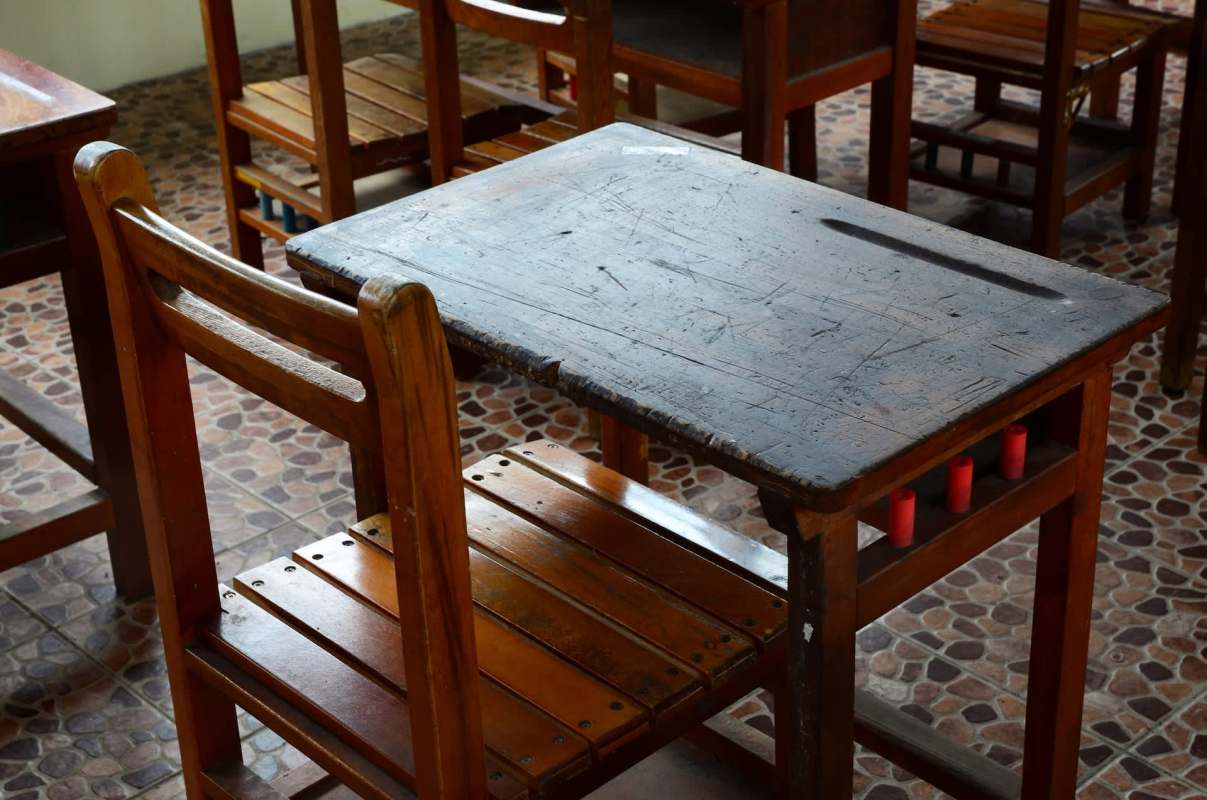A classroom with an old wooden school desk and chair.