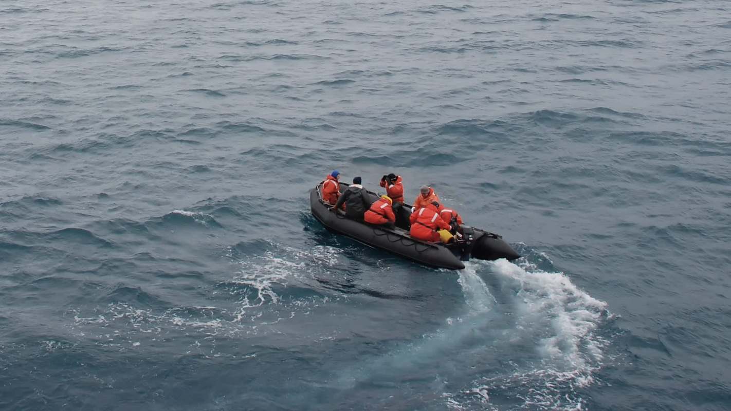 A crew in a rigid inflatable boat.