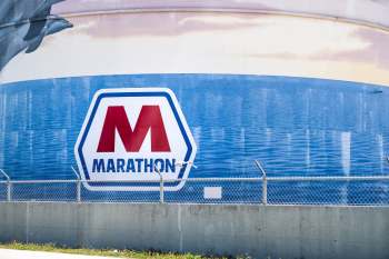 A large water tank featuring the Marathon logo and a blue water-themed mural.