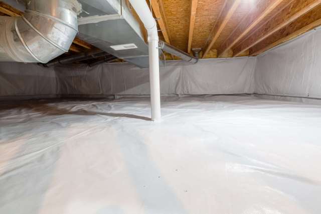 A clean, white plastic-covered basement with exposed wooden beams and pipes.