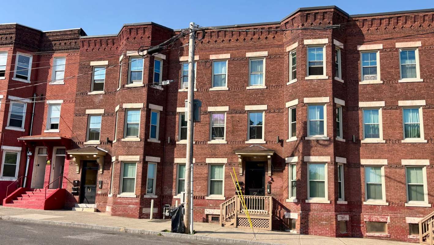 A brick apartment building with bay windows.