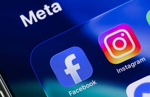 Logos of Facebook and Instagram displayed on a smartphone screen with the Meta brand name above.