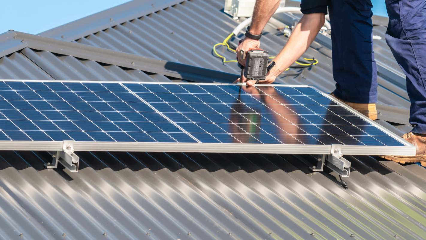 A person installing solar panels.