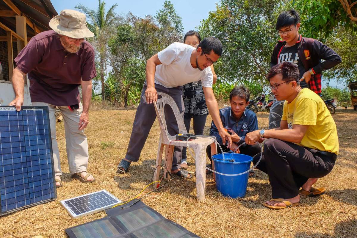 People in Myanmar using solar to power a water pump.
