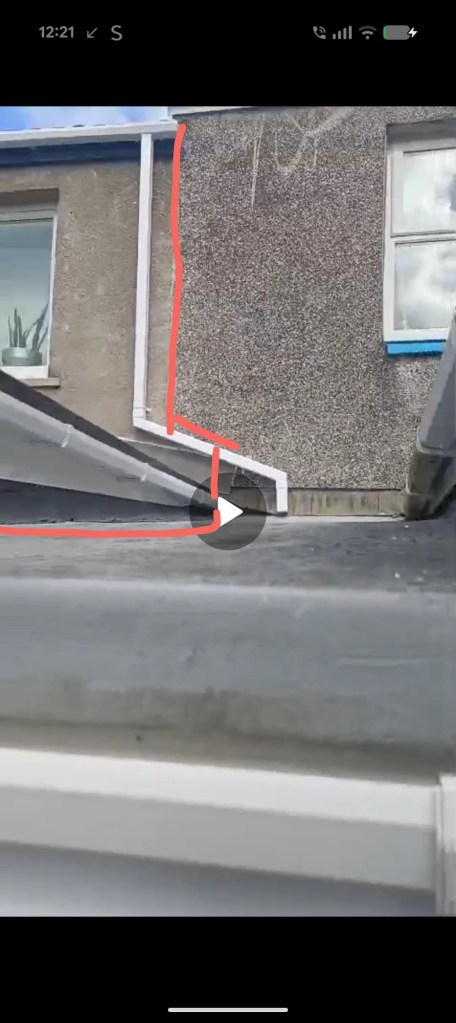 A drainpipe ending on a roof.