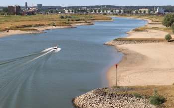 A boat on a river with low water levels.