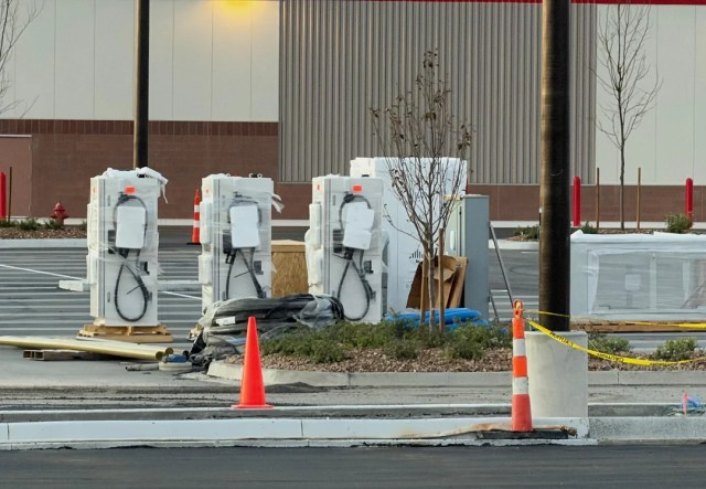 EV chargers ready for installation in a parking lot.