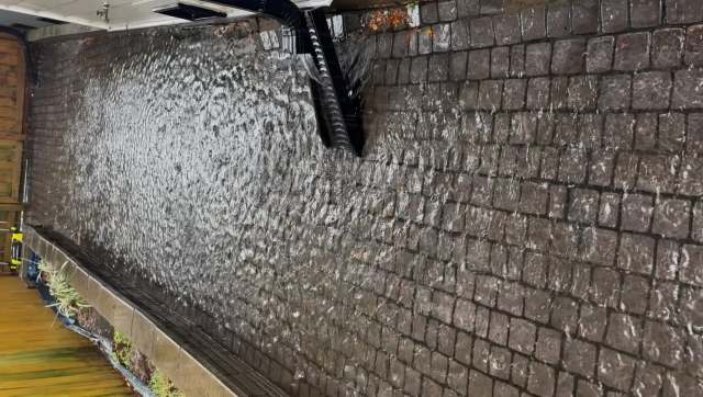 Water draining over a cobblestone path.