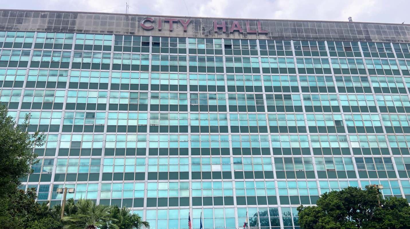 A large building with many windows labeled "CITY HALL" at the top.